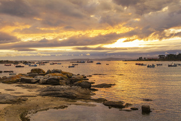 Fototapeta na wymiar Cloudy sunset on Abilleira beach