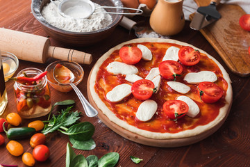 Step-by-step boss makes a pizza margarita. Dough and pizza ingredients