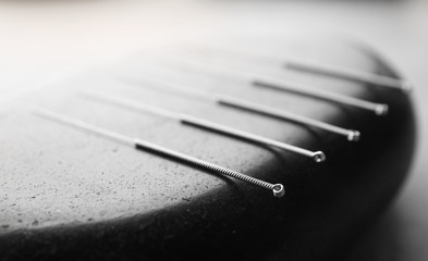 Stone and needles for acupuncture, closeup