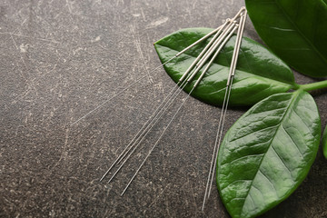Needles for acupuncture on dark textured background - obrazy, fototapety, plakaty