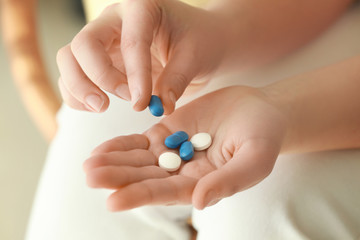 Hands of woman with pills, closeup