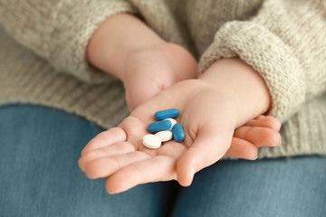 Hands of woman with pills, closeup
