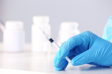 Hand of doctor with syringe in clinic, closeup