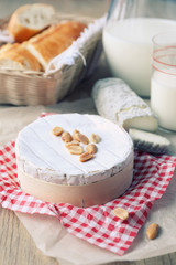 Fototapeta na wymiar Soft french cheeses, fresh baguette and milk. Toned image