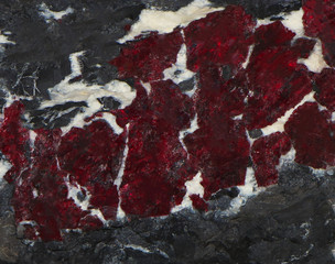 Shining cinnabar vein in grey stone texture