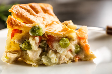 Piece of delicious chicken pot pie on plate, closeup