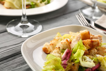 Plate with chicken salad on table