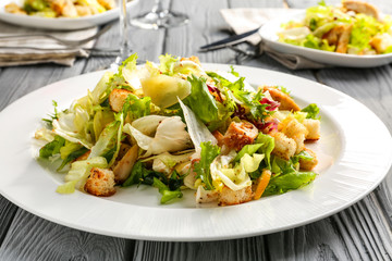 Plate with chicken salad on table