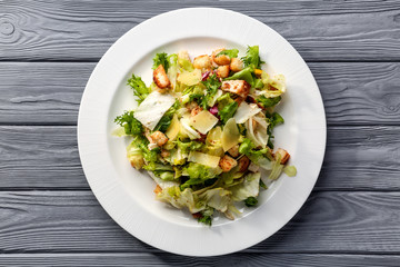 Plate with chicken salad on table