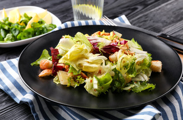 Plate with chicken salad on table