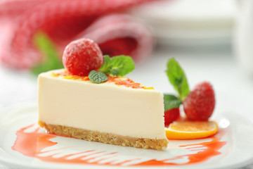 Tasty cheesecake slice with berries on plate