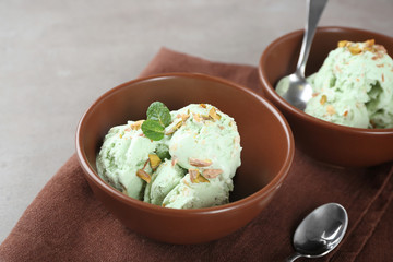 Bowls with pistachio ice cream on table