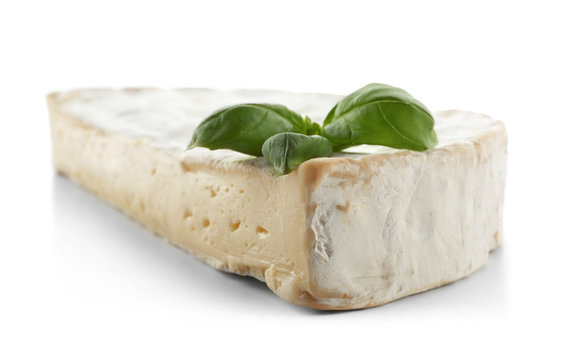 Tasty cheese and basil on white background, closeup