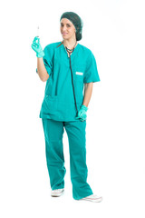 Young nurse with stethoscope standing and looking syringe in hand isolated .