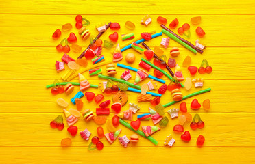 Composition of tasty jelly candies on wooden background