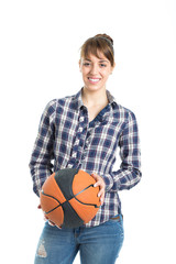 Happy attractive young woman holding a basketball isolated on white background.