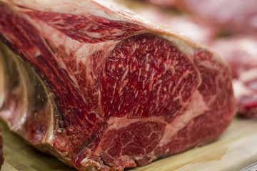 Close-up of a piece of raw meat in butcher shop window