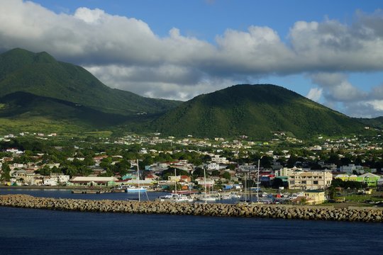 Saint Kitts Island landscape -  view from water on a brignt sunny day with some white clouds and marina in the foreground
