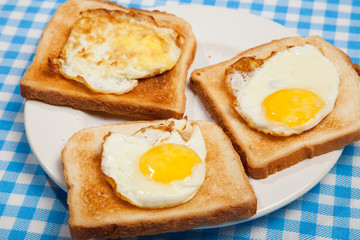 Breakfast. Toast and eggs on a blue table