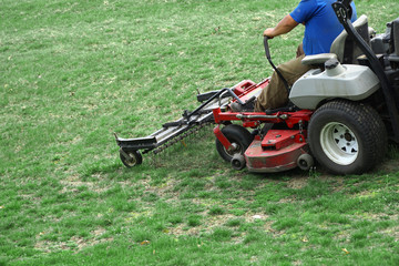 Fototapeta na wymiar outdoor worker working on mowing the lawn