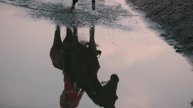 A girl riding a horse, reflected in water