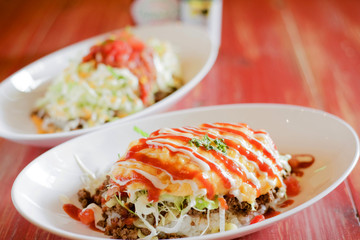 Okonomiyaki Japanese pancakes on white dish