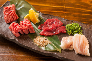 Fresh raw red beef with lemon on stone cutting board