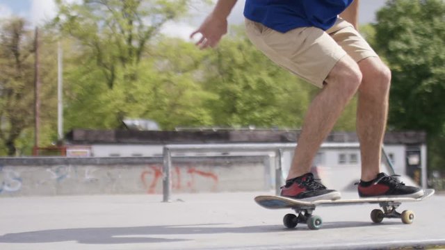 Close up shot of a skateboarder doing a kick flip, in slow motion