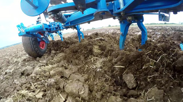 Video-footage Camera on a plow of a tractor on a field