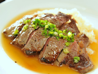 Fried rice with sliced beef and onion on white dish