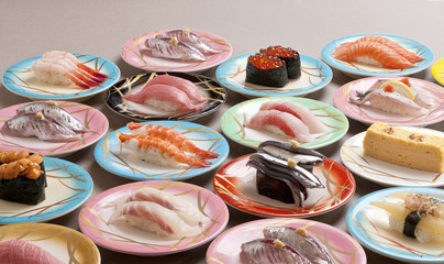 Large meal of shushi sashimi with shrimp, salmon, tuna, squid and makerel
