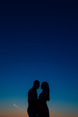 Fototapeta na wymiar Silhouettes at sunset on the beach in Montenegro