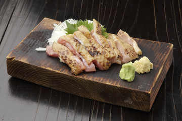 Roasted chopped chicken with wasabi on wooden platter