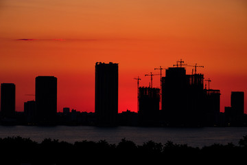 Orange sunset with Miami skyline and construction