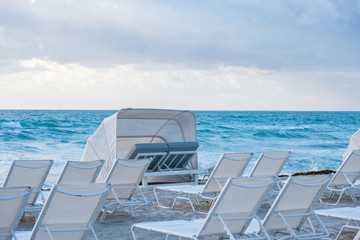 White chairs and umbrella on the beach