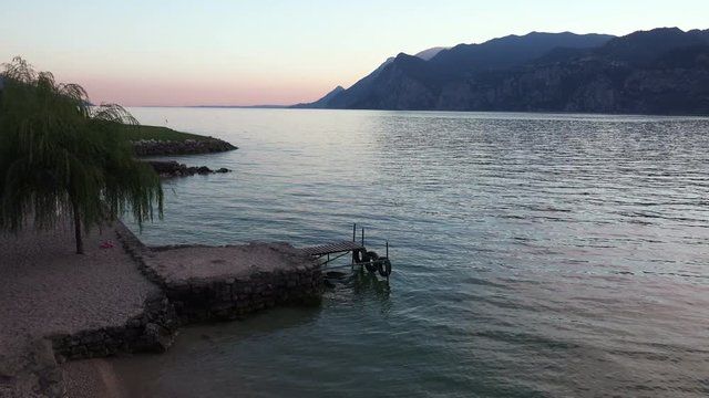 Sunset on the Garda Lake between Mountais, Italy. 4K 
