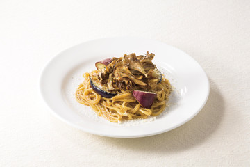 Spaghetti pasta noodle with sweet potatoes and salt on white platter