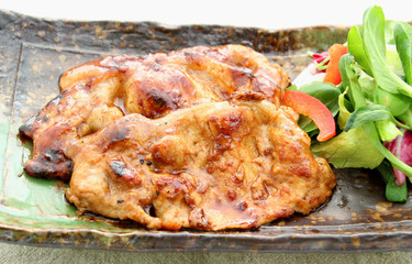Fried pork with fresh green cabbage on platter