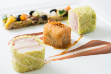 Rolls of pork and white cabbage on white background