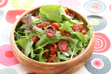 Special salad of cabbage and tomatoes in wooden bowl