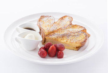 Grilled bread in heart shape with strawberry and cream