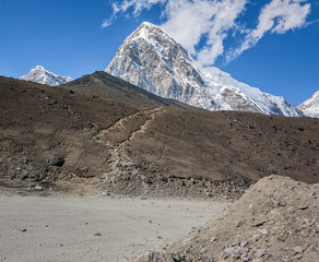 View of the Mount Everest region from Gorak Shep village to slope of the Kala Patthar and PumoRi...