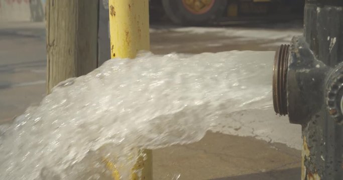  slow motion shot of a broken fire hydrant in Brooklyn, New York.