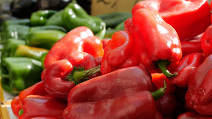 Fresh peppers with price on display in market.