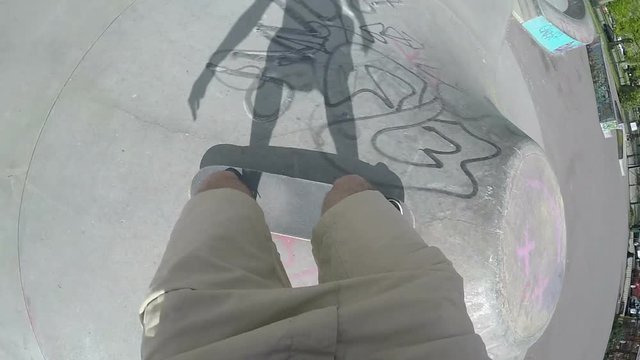 Point of view shot of skateboarder making a ramp jump and then messing up a flip, in slow motion 