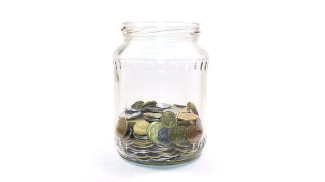 Time Lapse of Falling Coins in the Jar on white background. 4K