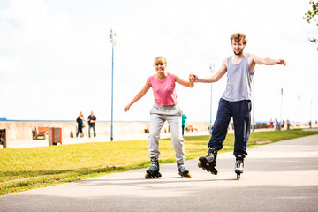 Active people friends rollerskating outdoor.