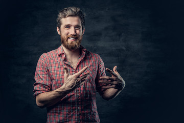 Bearded male dressed in a red fleece shirt makes conversation.