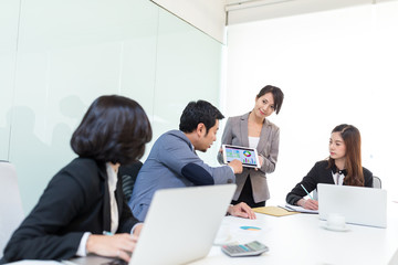 Group of business people discuss in meeting room