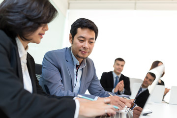 Business people discuss on laptop computer